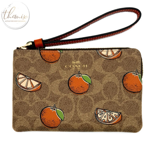 COACH Corner Zip Signature Wristlet with Orange Print